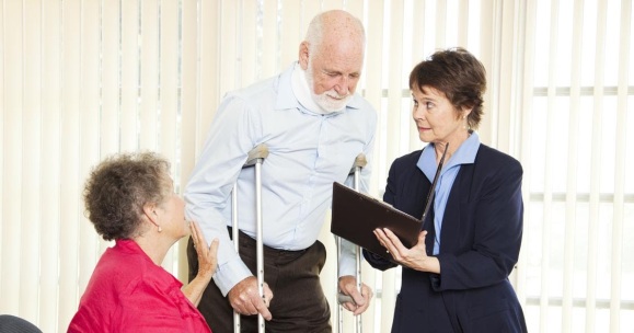 Injured man and his wife meet with a personal injury lawyer.